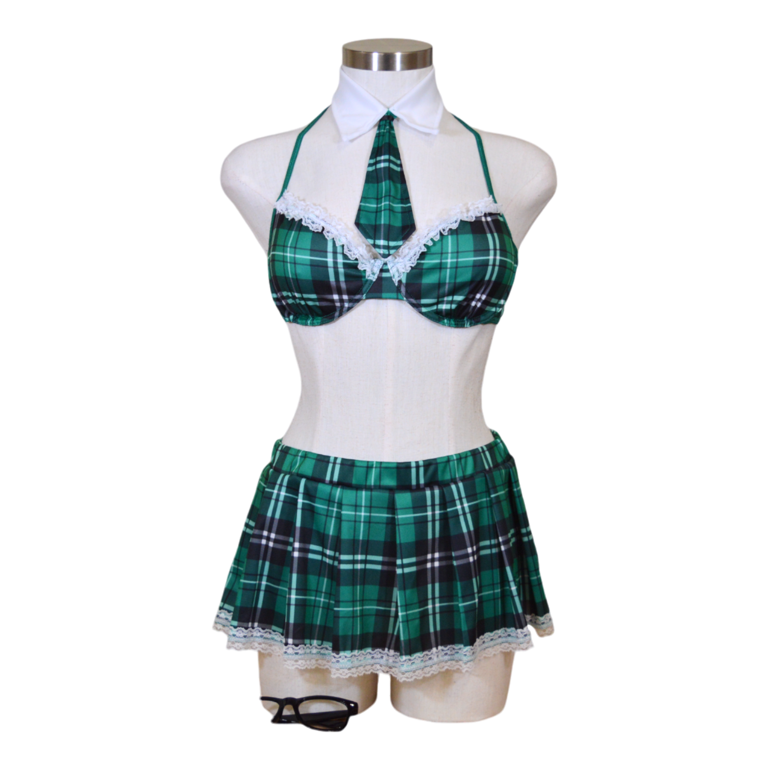 A mannequin wearing a green plaid schoolgirl costume with a bra top, skirt, and glasses.