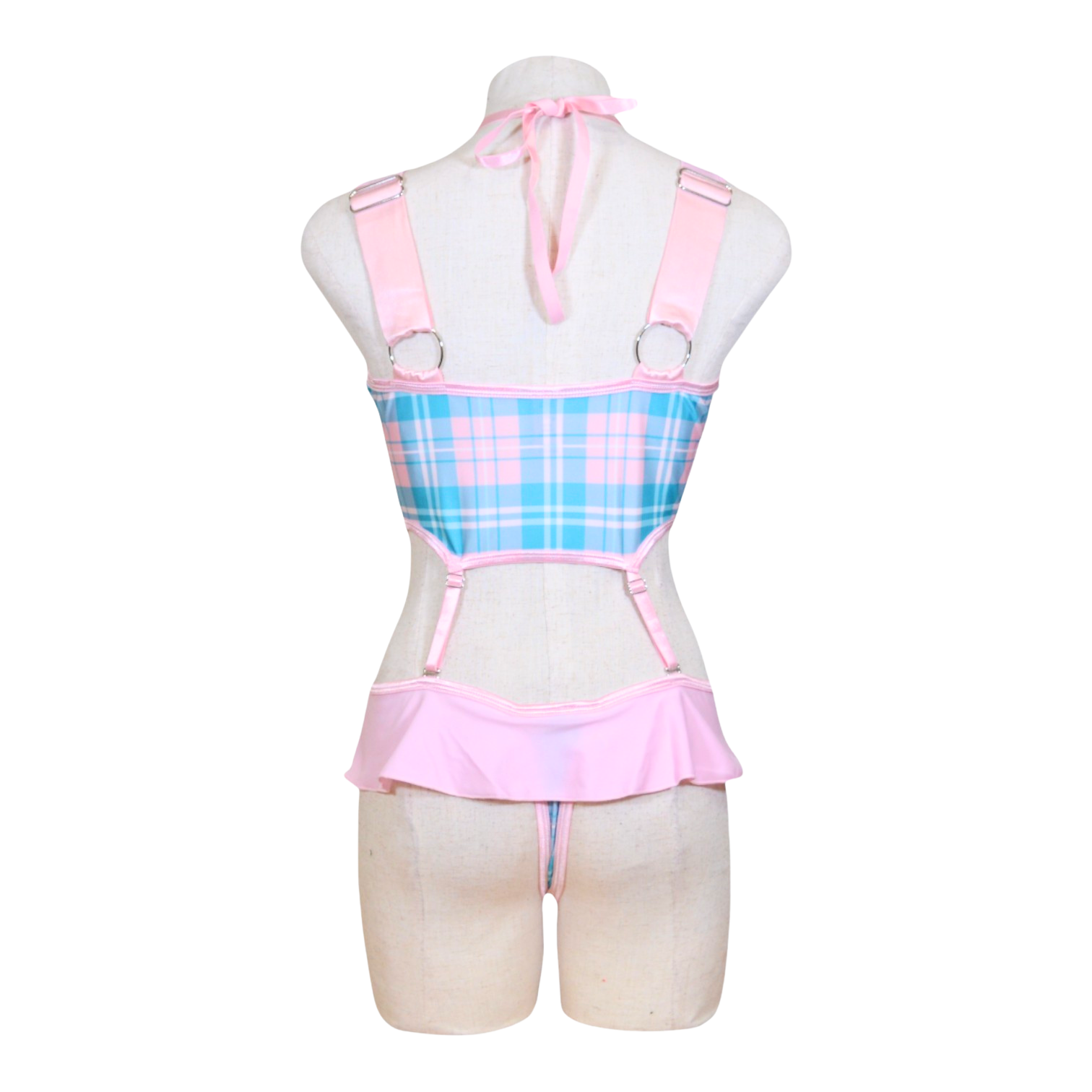 A mannequin displaying a pink and blue plaid schoolgirl role play costume with adjustable straps and a bow tie at the neck.