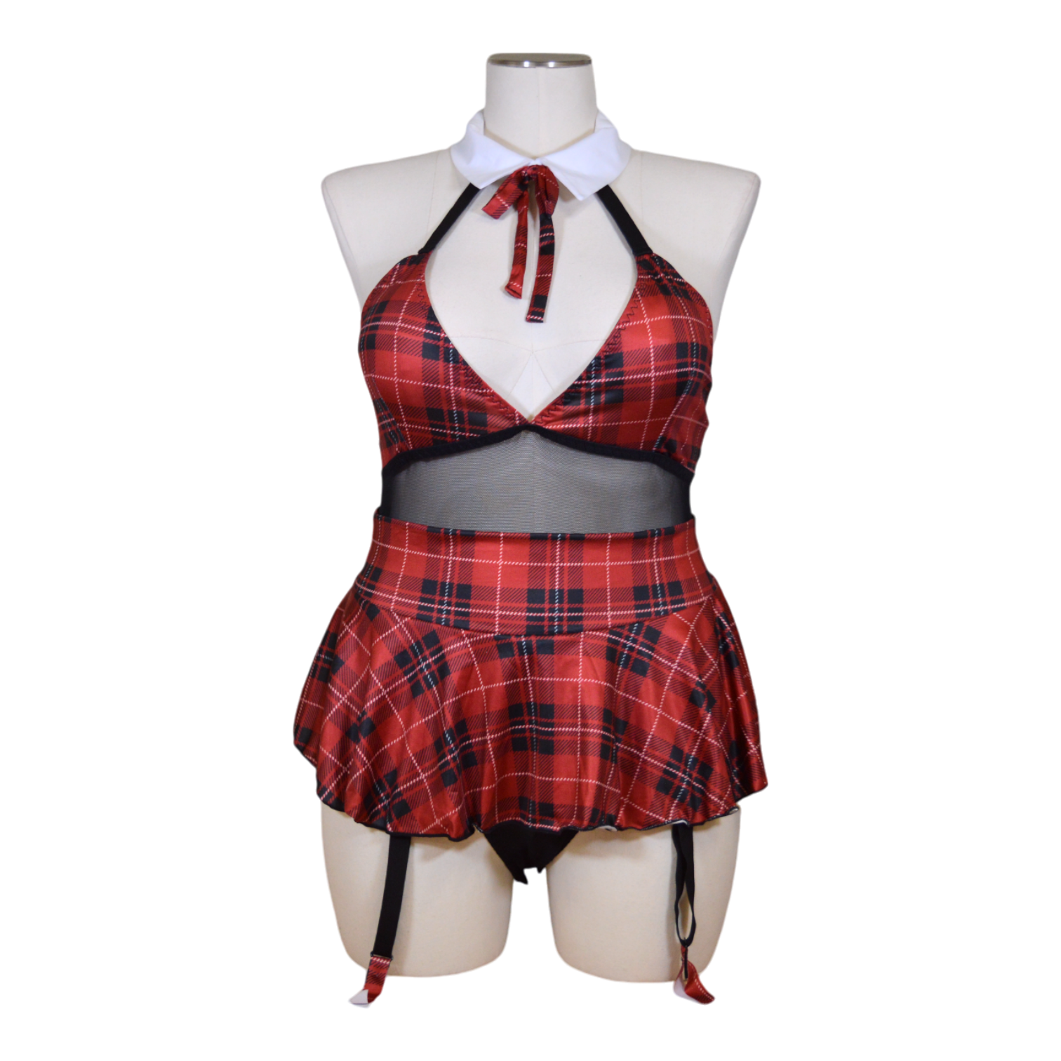 A mannequin wearing a red and black plaid teddy with a halter neck, sheer mesh, a skirt, and garter straps.