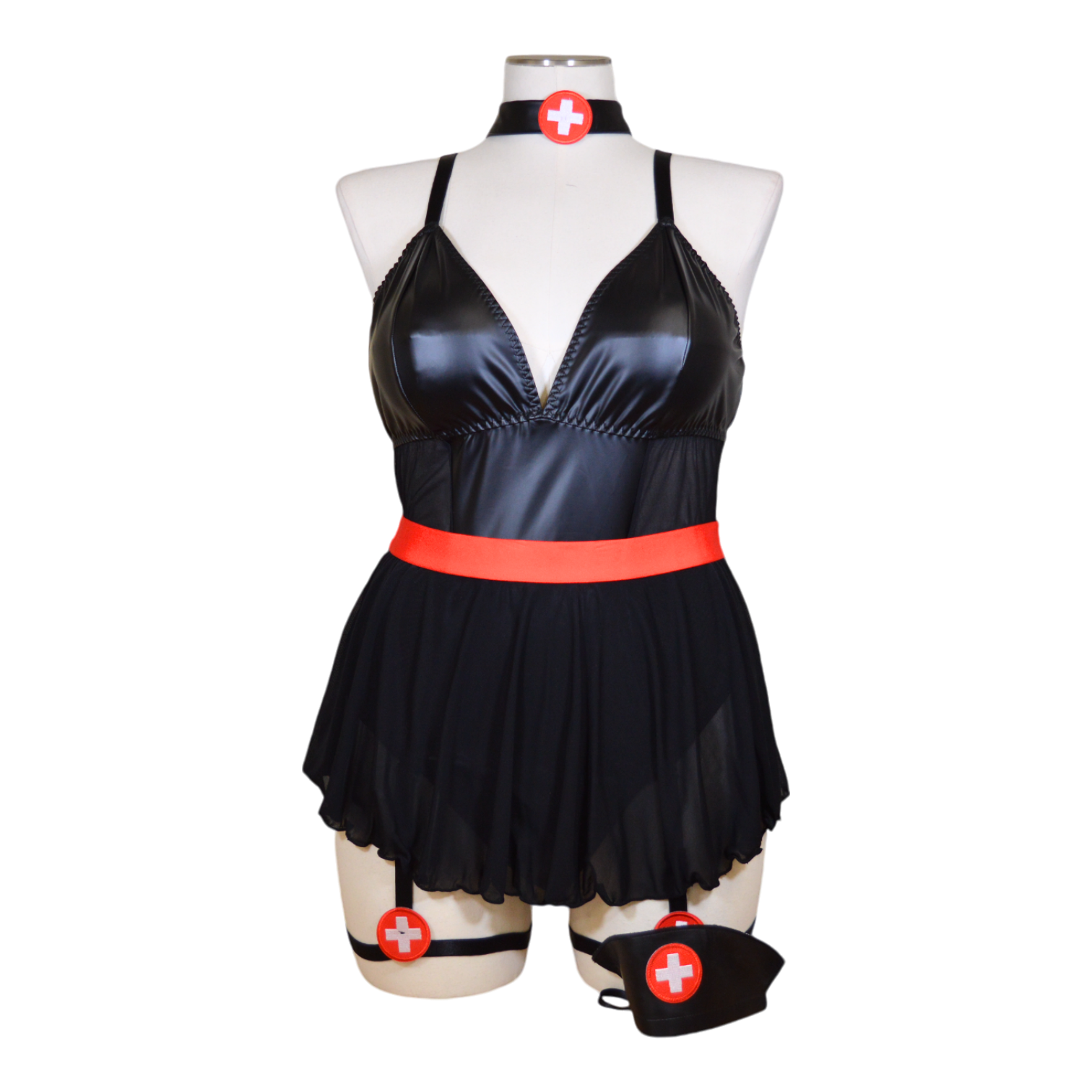 A black leather nurse costume displayed on a mannequin, featuring a revealing neckline, a red belt, and garter straps. Accessories including a choker and hat are also visible.