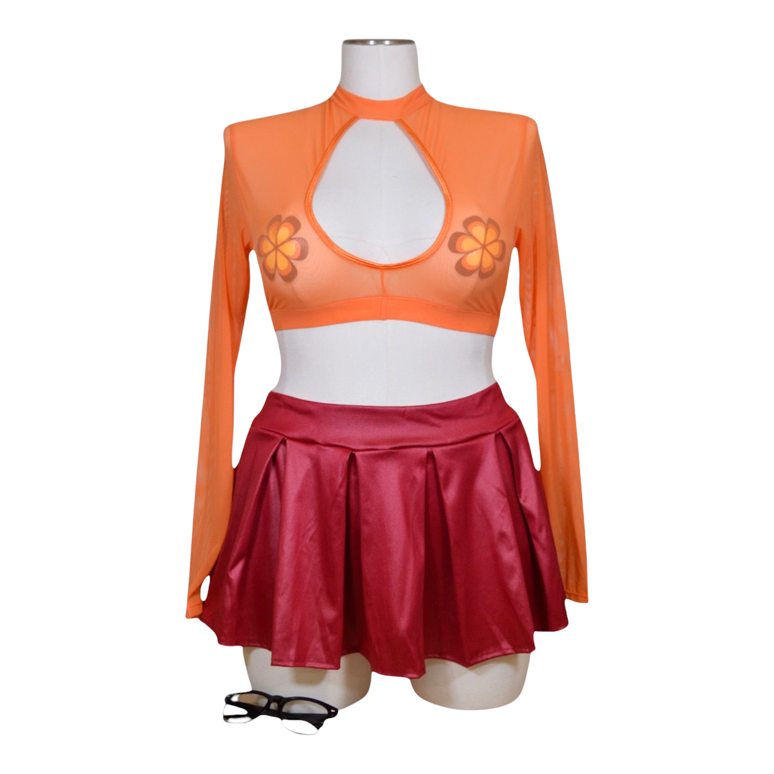 An orange long sleeve crop top with floral cut-outs and a keyhole back, paired with a red pleated mini skirt. Accessories including pasties are included.