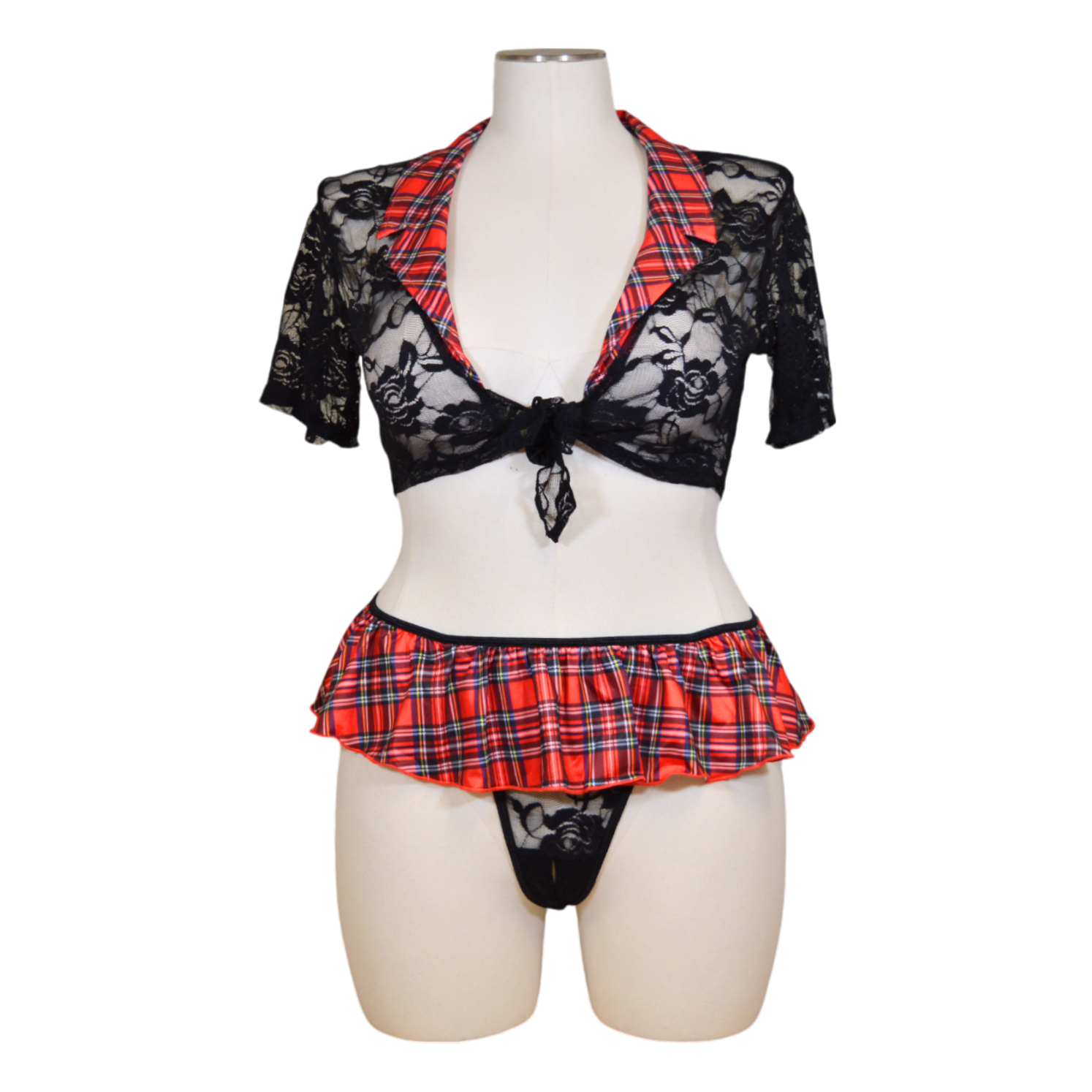 A mannequin showcasing a black lace top and a red and black plaid skirt with a matching lingerie-style thong.
