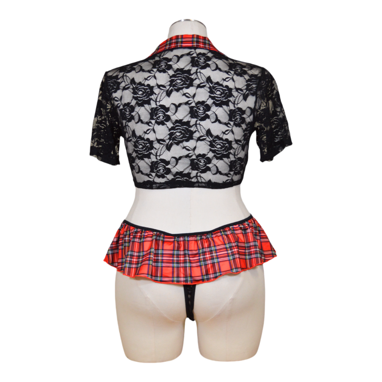A mannequin showcasing a black lace top and a red and black plaid skirt with a matching lingerie-style thong.
