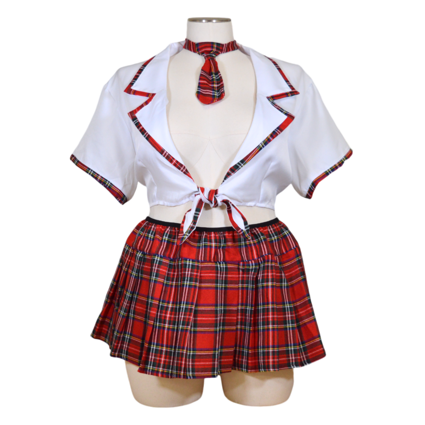 A mannequin displaying a white tie top and red and black plaid pleated skirt with necktie.