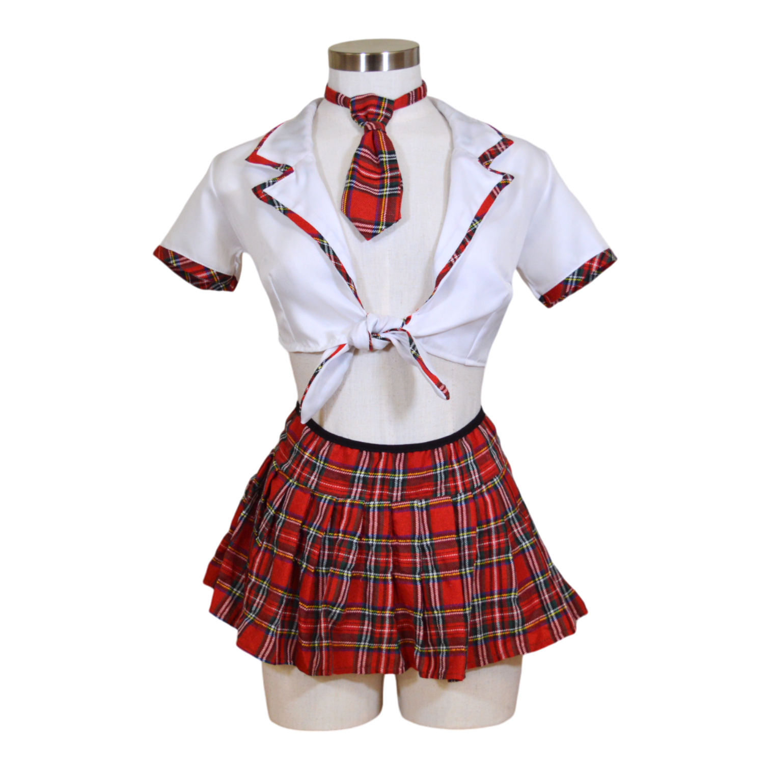 A mannequin wearing a white cropped top with a tie front and attached collar, and a matching plaid mini skirt with a plaid tie.
