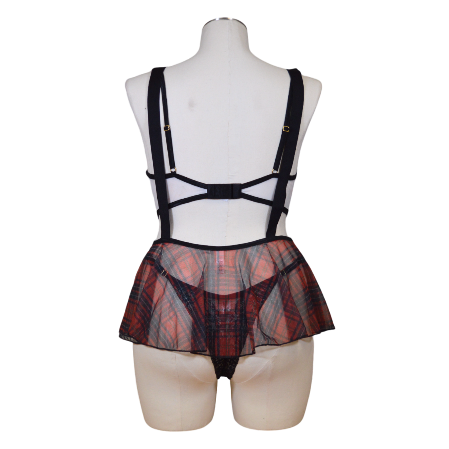 A mannequin displaying a sexy school girl costume set, including a plaid skirt and suspenders on a mannequin.