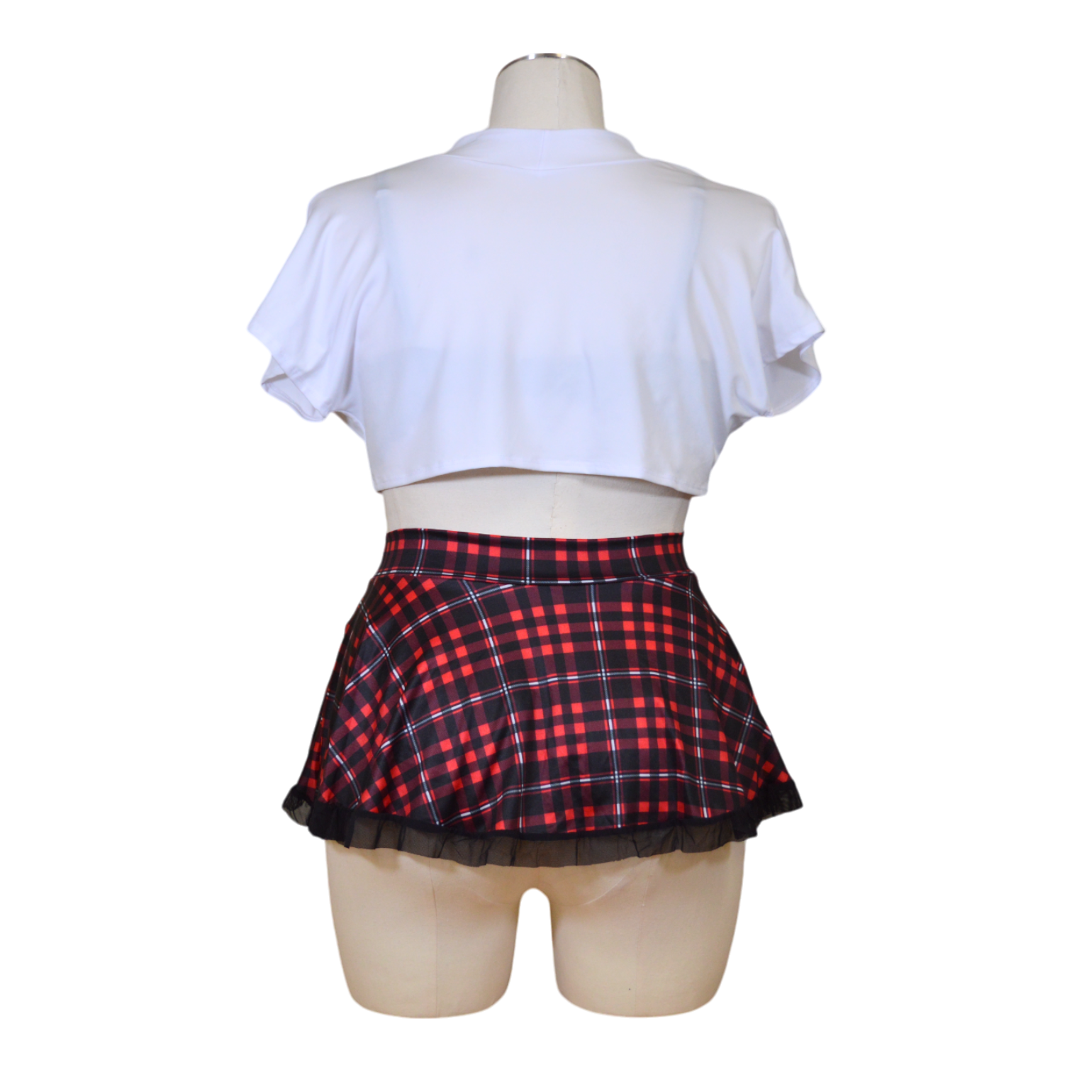 A mannequin wearing a flirty outfit with a lace bra, white tie shirt, and red plaid skirt.