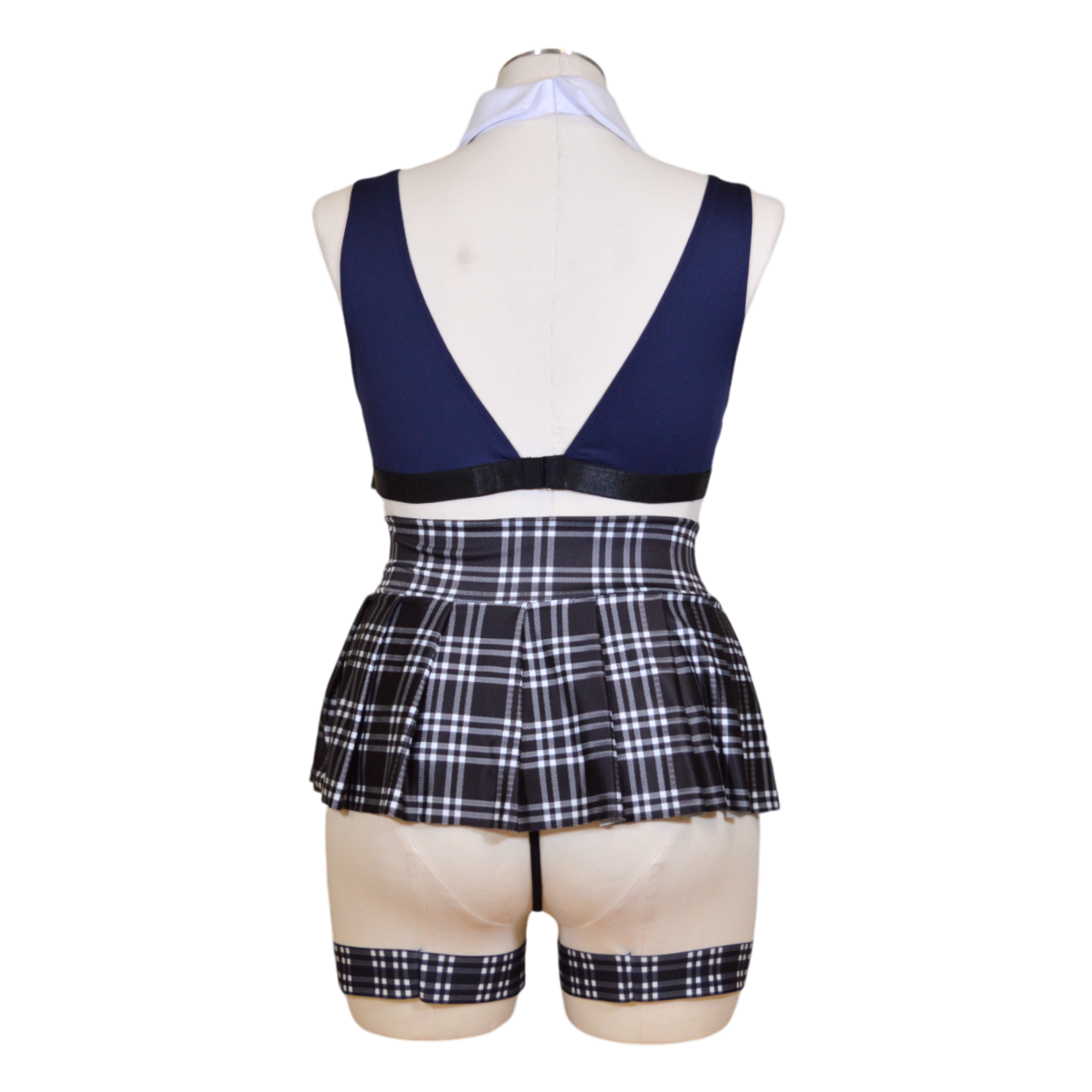 A school uniform ensemble consisting of a blue bralette with an academy patch, a pleated blue plaid skirt, matching leg garters, a g-string panty, and a red necktie back view.