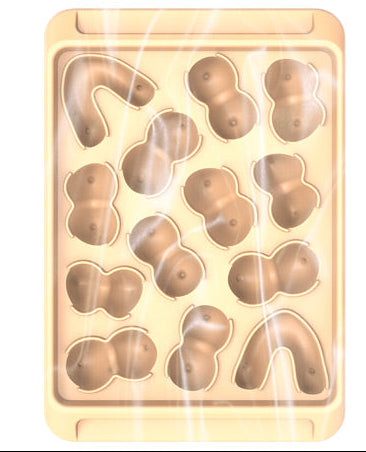 Packaging and a clear plastic ice cube tray with molded shapes designed to make 14 ice cubes, labeled 'Boobie Ice Cube Tray'.
