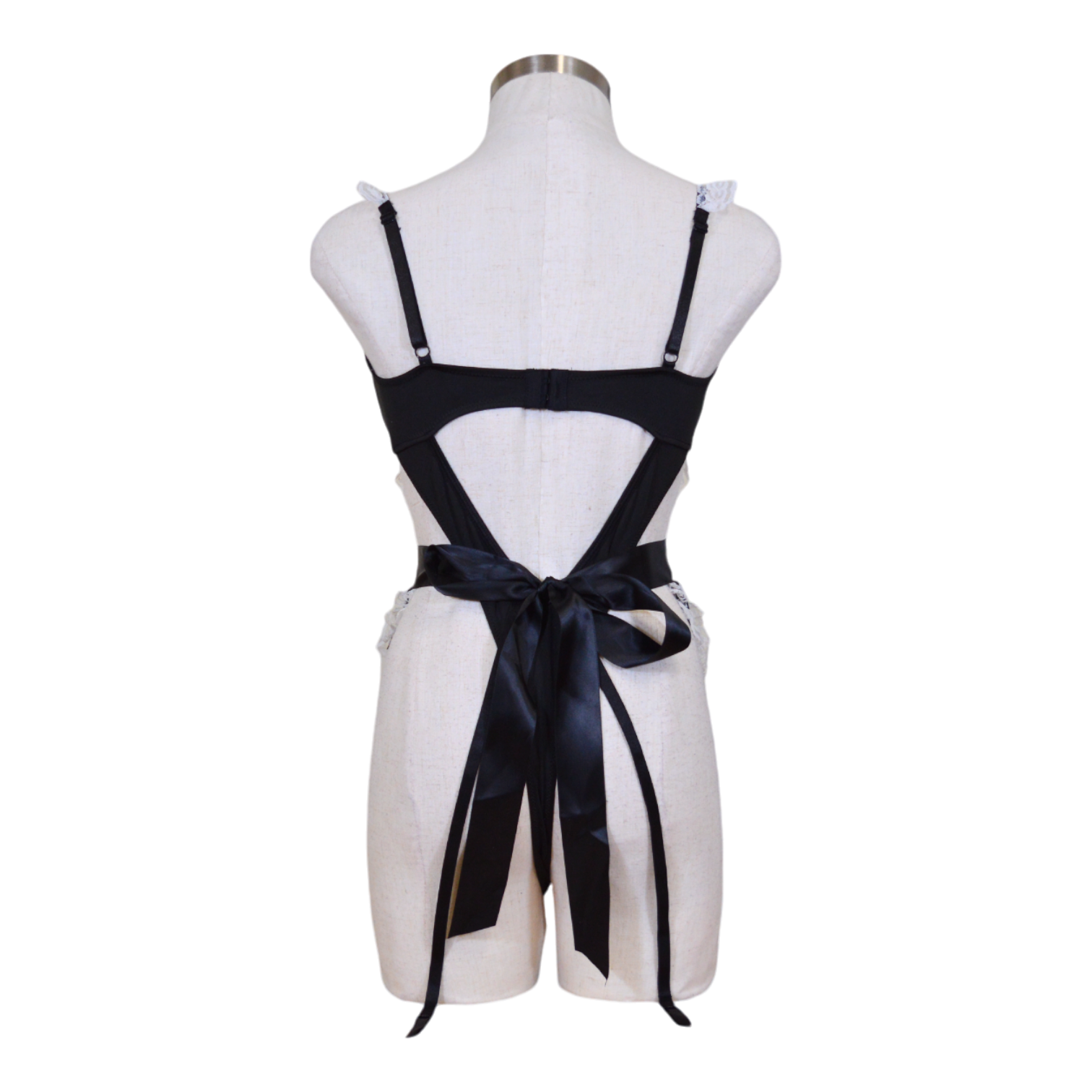 A mannequin displaying a black teddy style maid costume with white lace accents, including garter straps and an apron with the word 'Dirty' written on it. Back view.