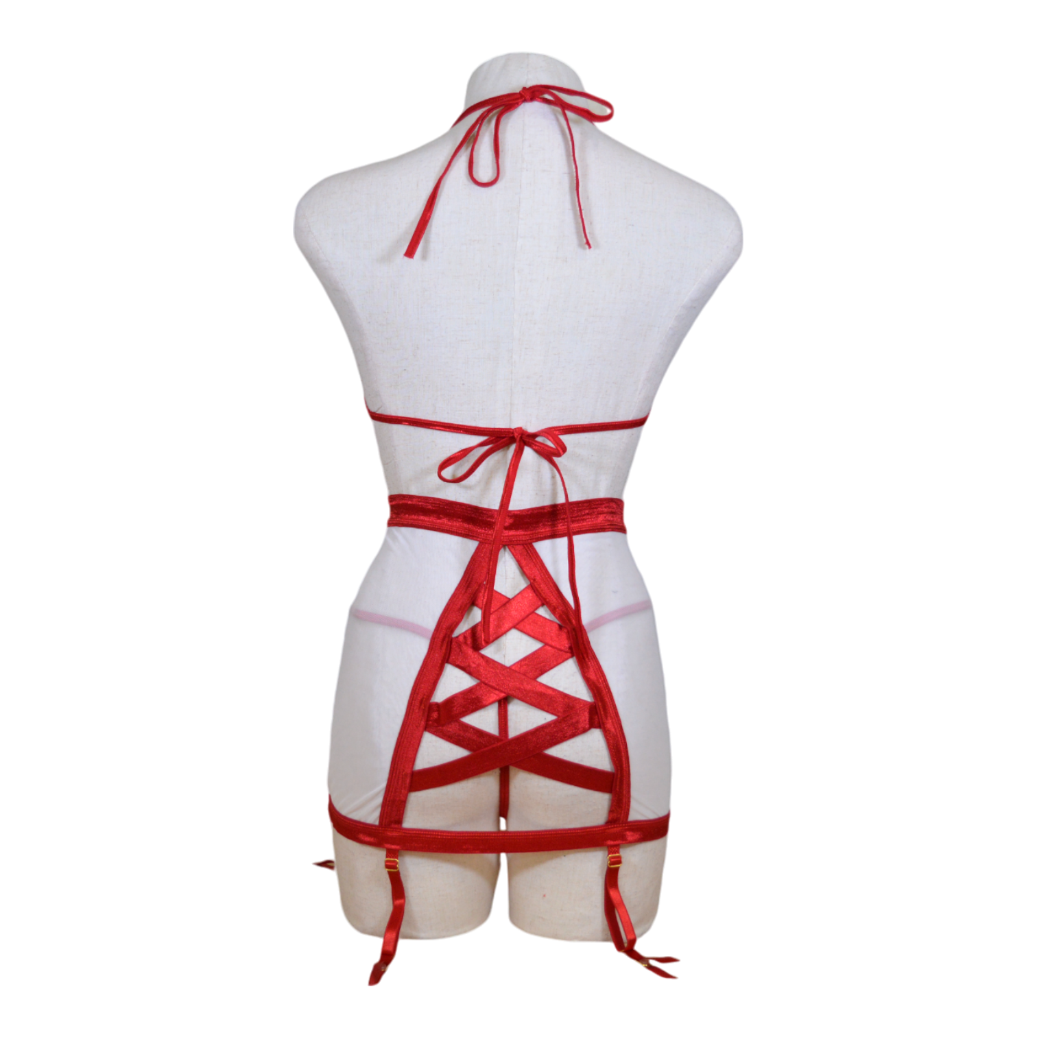A mannequin wearing a red and white satin nurse bra set with a high-waist mesh skirt, a satin elastic thong, and a headpiece. Back view.