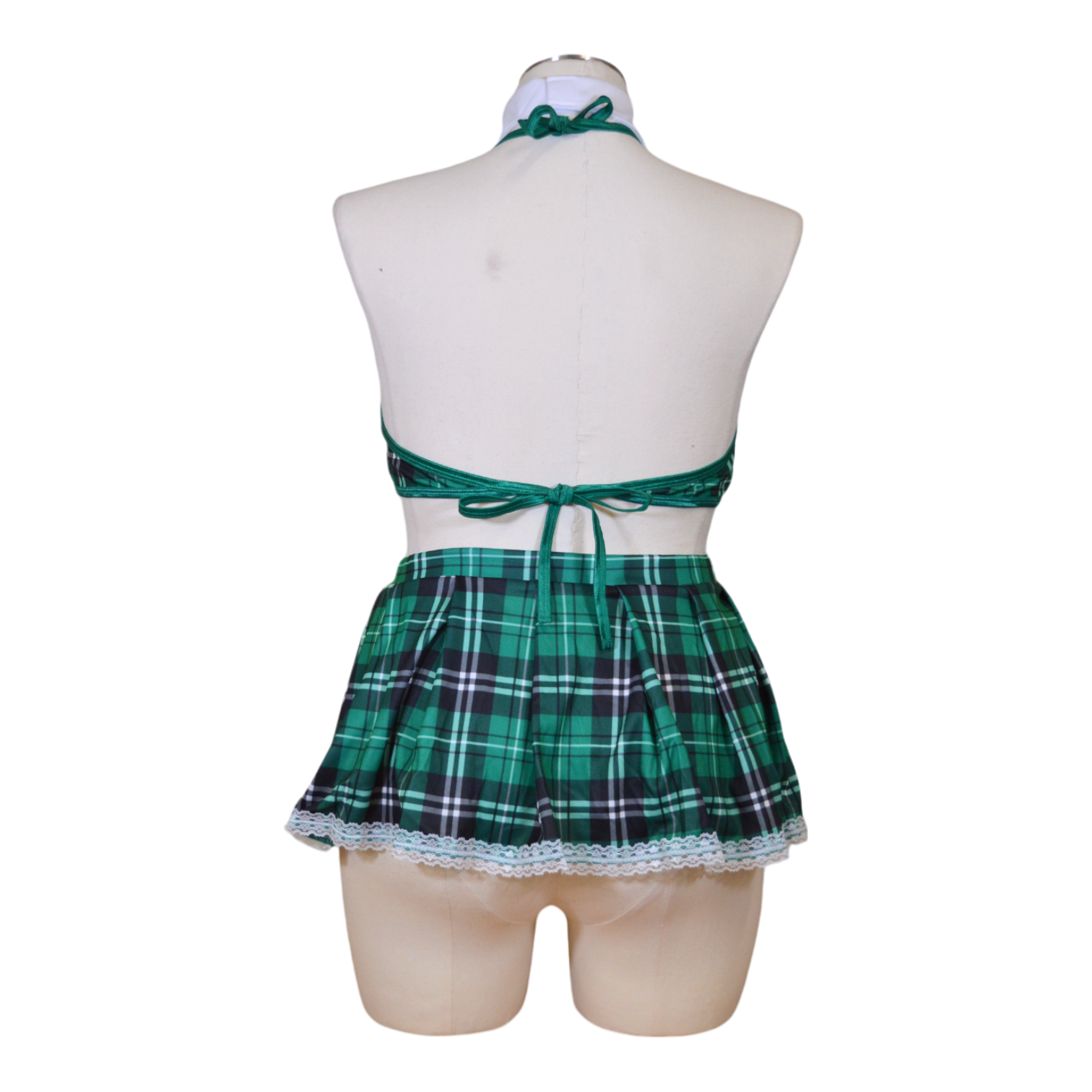 A mannequin wearing a green plaid schoolgirl costume set which includes a bra top, a skirt, and glasses. Back view.