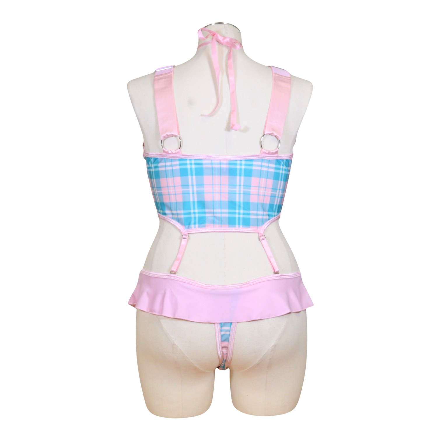 A mannequin displaying a pink and blue plaid schoolgirl role play costume with adjustable straps and a bow tie at the neck.