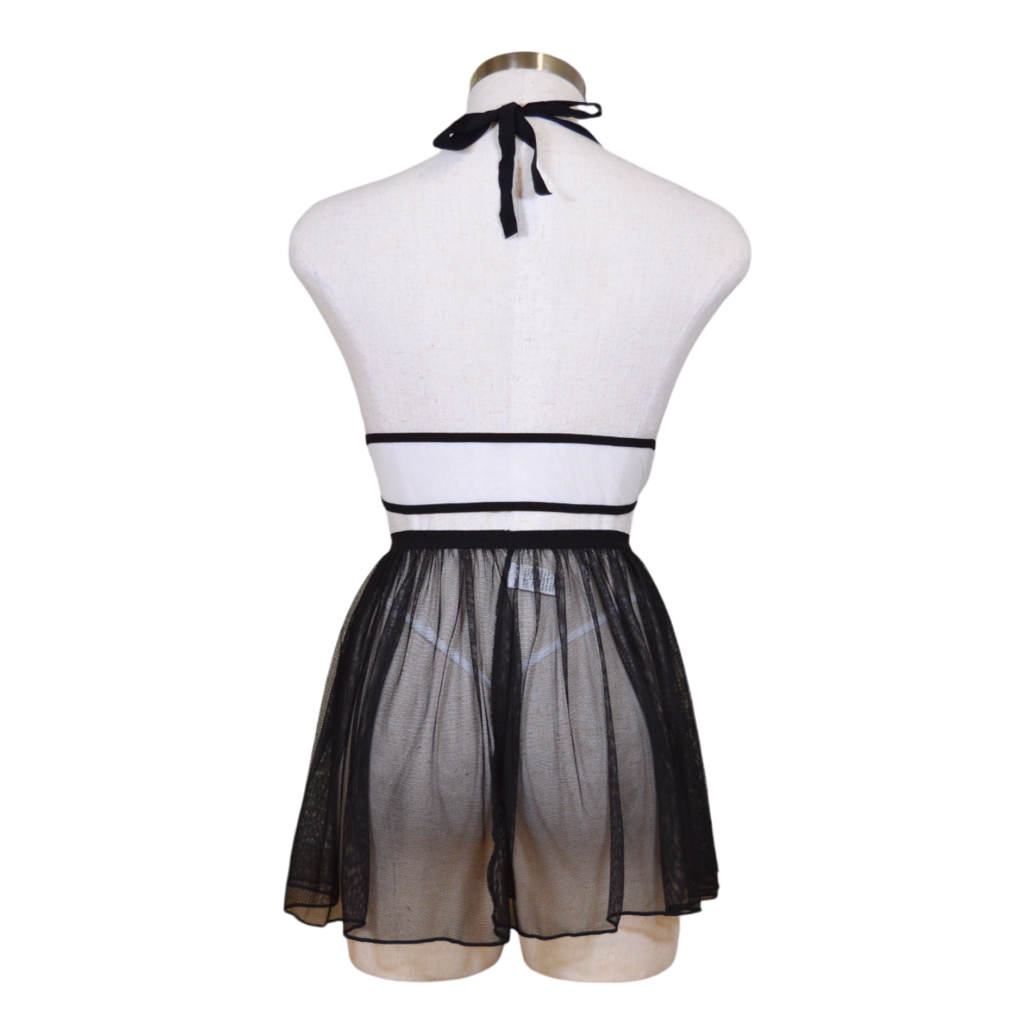 This image features a playful and seductive three-piece lingerie set, presented in a maid-inspired theme. The set includes a white underwired bra with delicate lace detailing and a flirty attached skirt, tied together with a black ribbon at the neck for a charming and flirty look back view.
