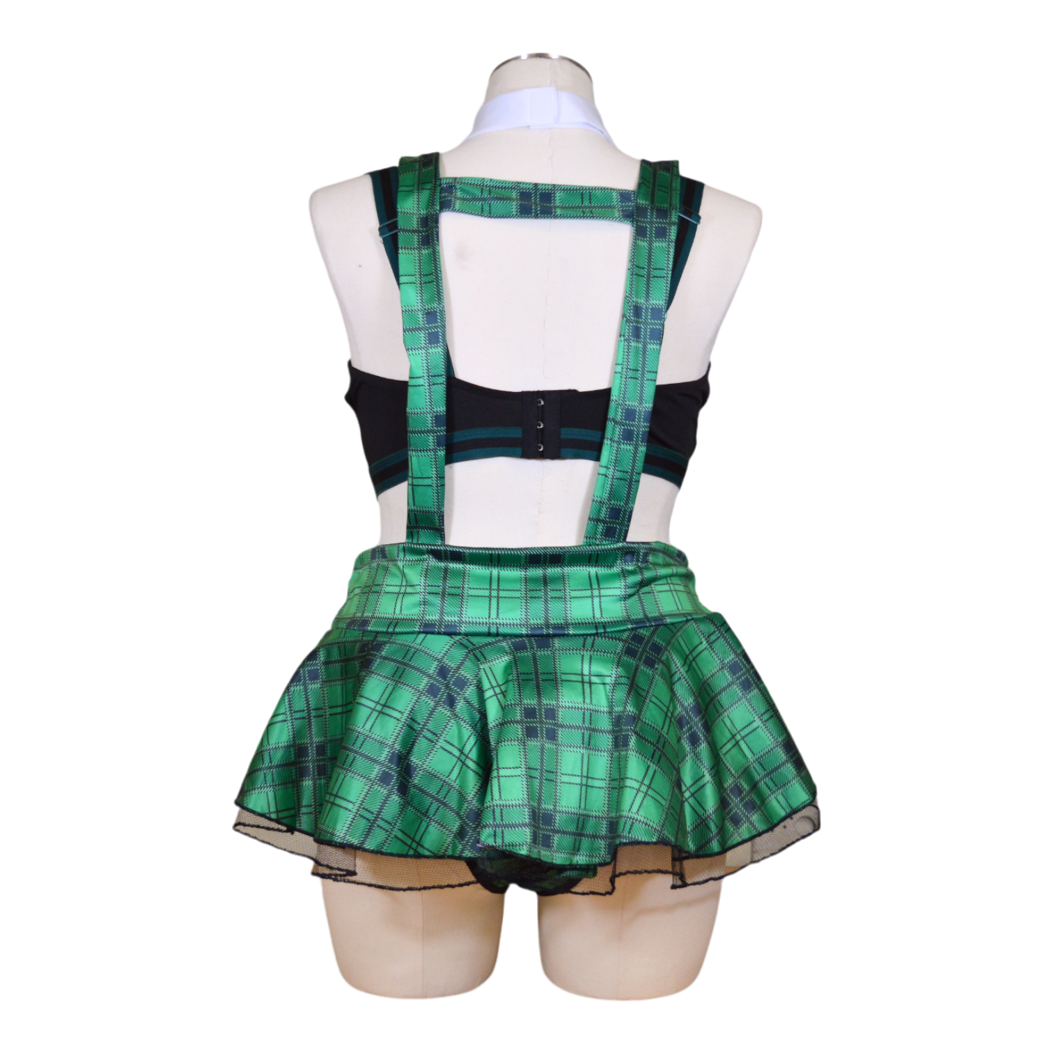 A mannequin displaying a black bra, green plaid skirt, necktie, and black panties arranged as a costume set.