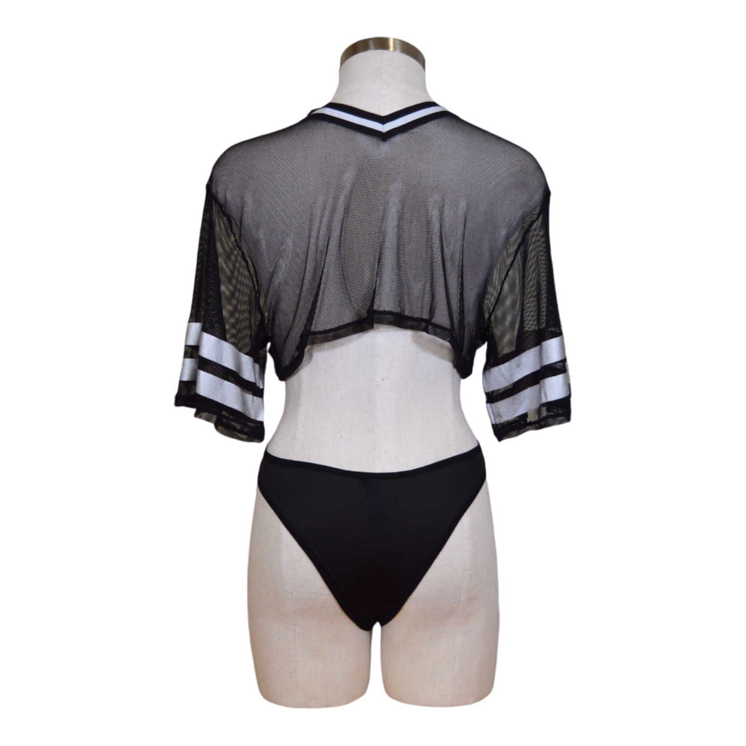 A mannequin displaying a black lingerie set, including a mesh top with 'MVP' text and lace-up panties.