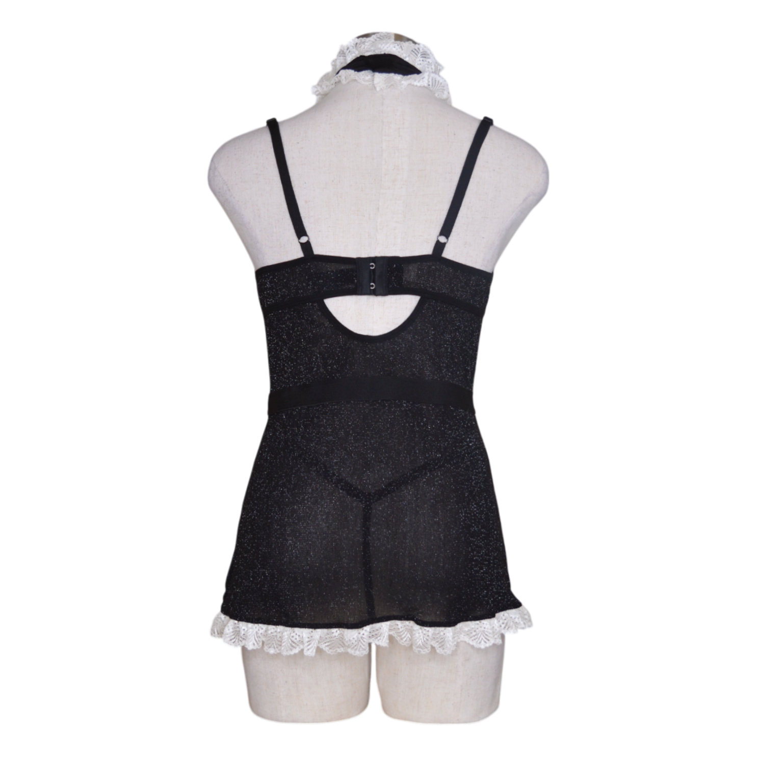 A black and white lingerie set including a chemise with apron detail, underwire cups, hook-and-eye back closure, a G-string panty, and a ruffle choker.