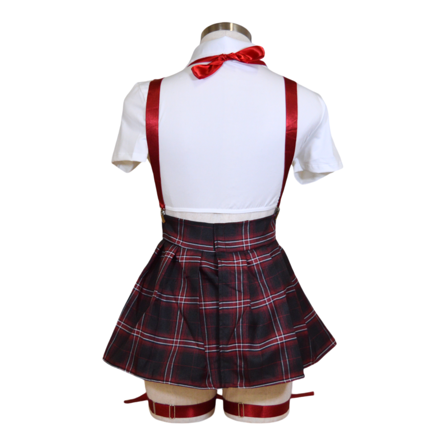 A school girl costume ensemble featuring a white mesh shirt, a plaid skirt, red suspenders, a neck tie, and garter straps with bows.