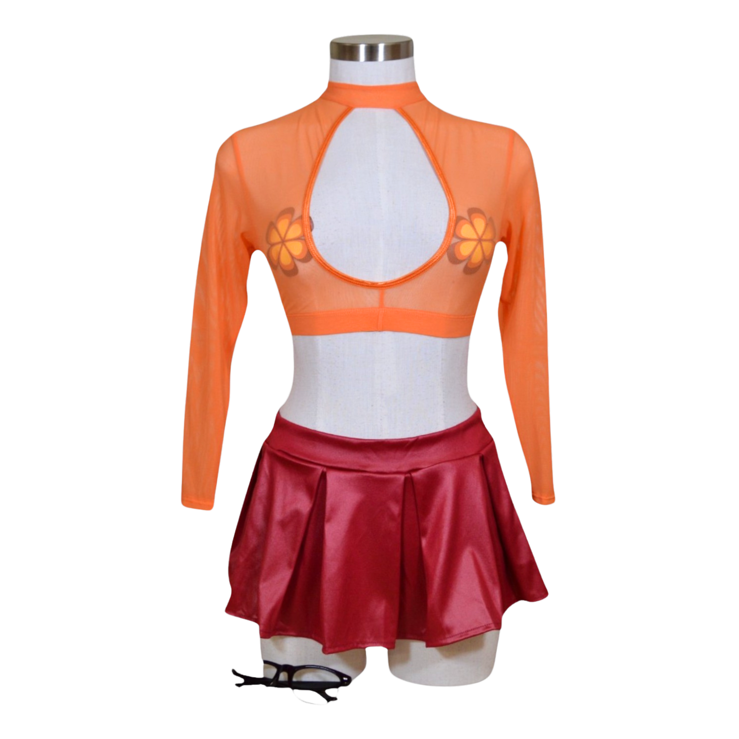 An orange long sleeve crop top with a floral pattern, paired with a red mini skirt, displayed on a mannequin. Also shown are a pair of flower pasties.