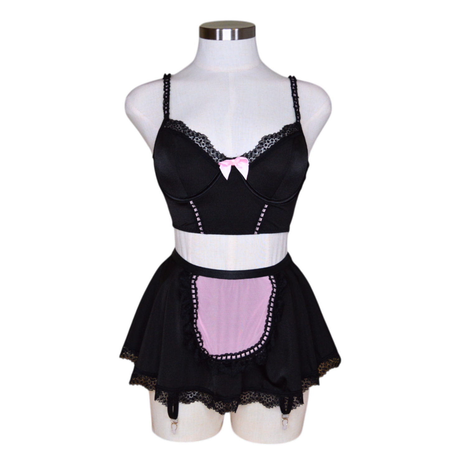 A black lingerie set with pink accents, featuring garter straps and lace detailing, displayed on a mannequin.