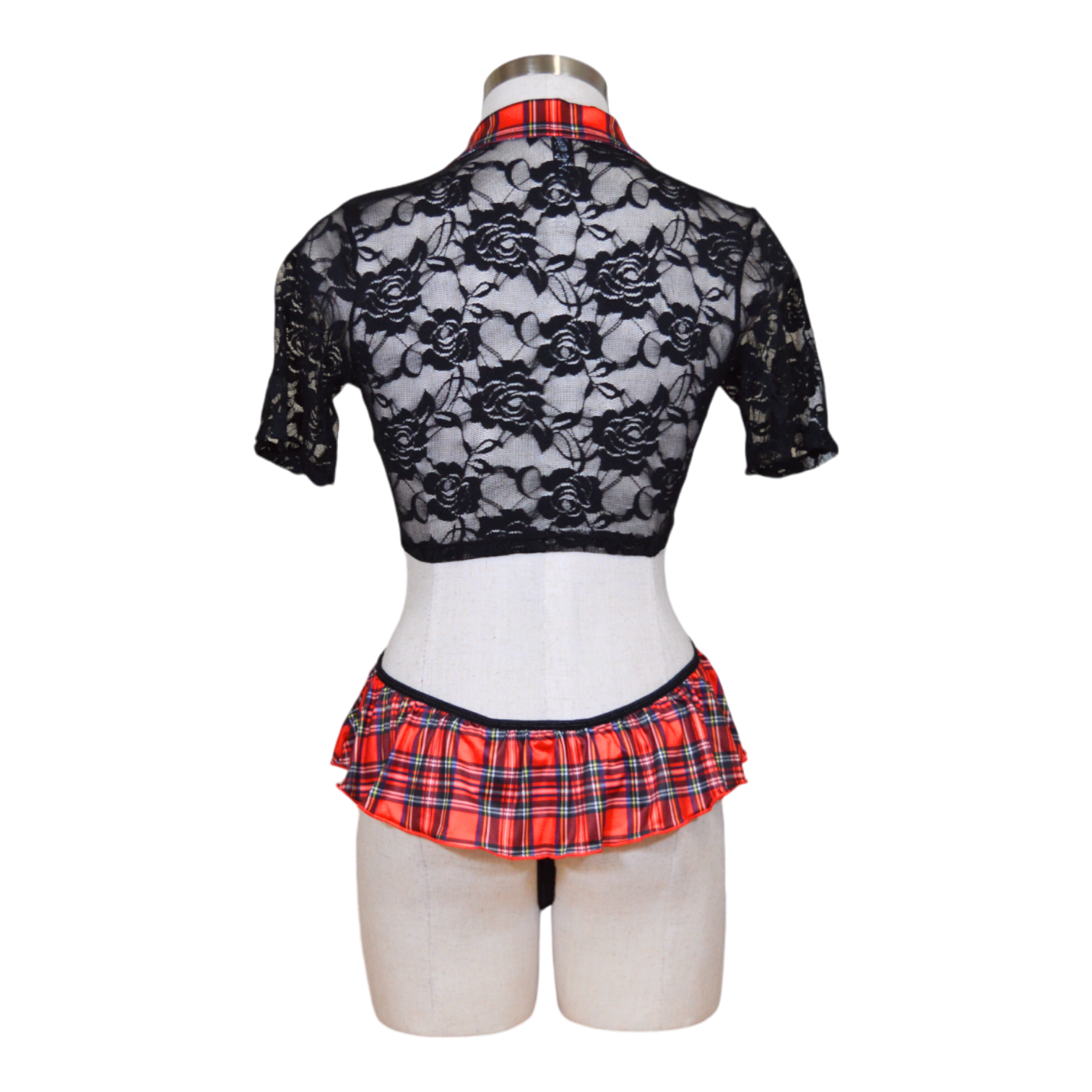 A mannequin showcasing a black lace top and a red and black plaid skirt with a matching lingerie-style thong.