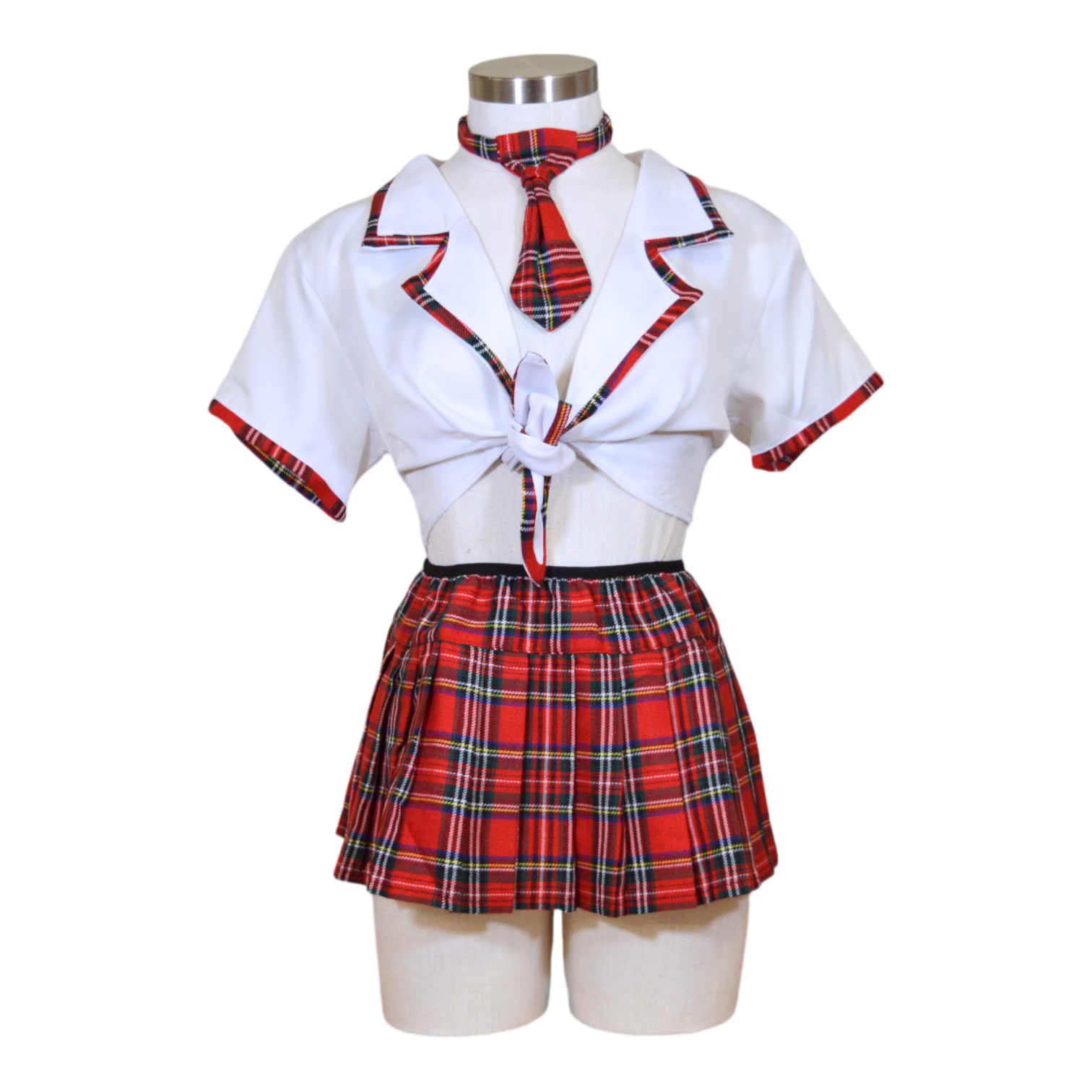 A mannequin displaying a white tie top and red and black plaid pleated skirt with necktie.