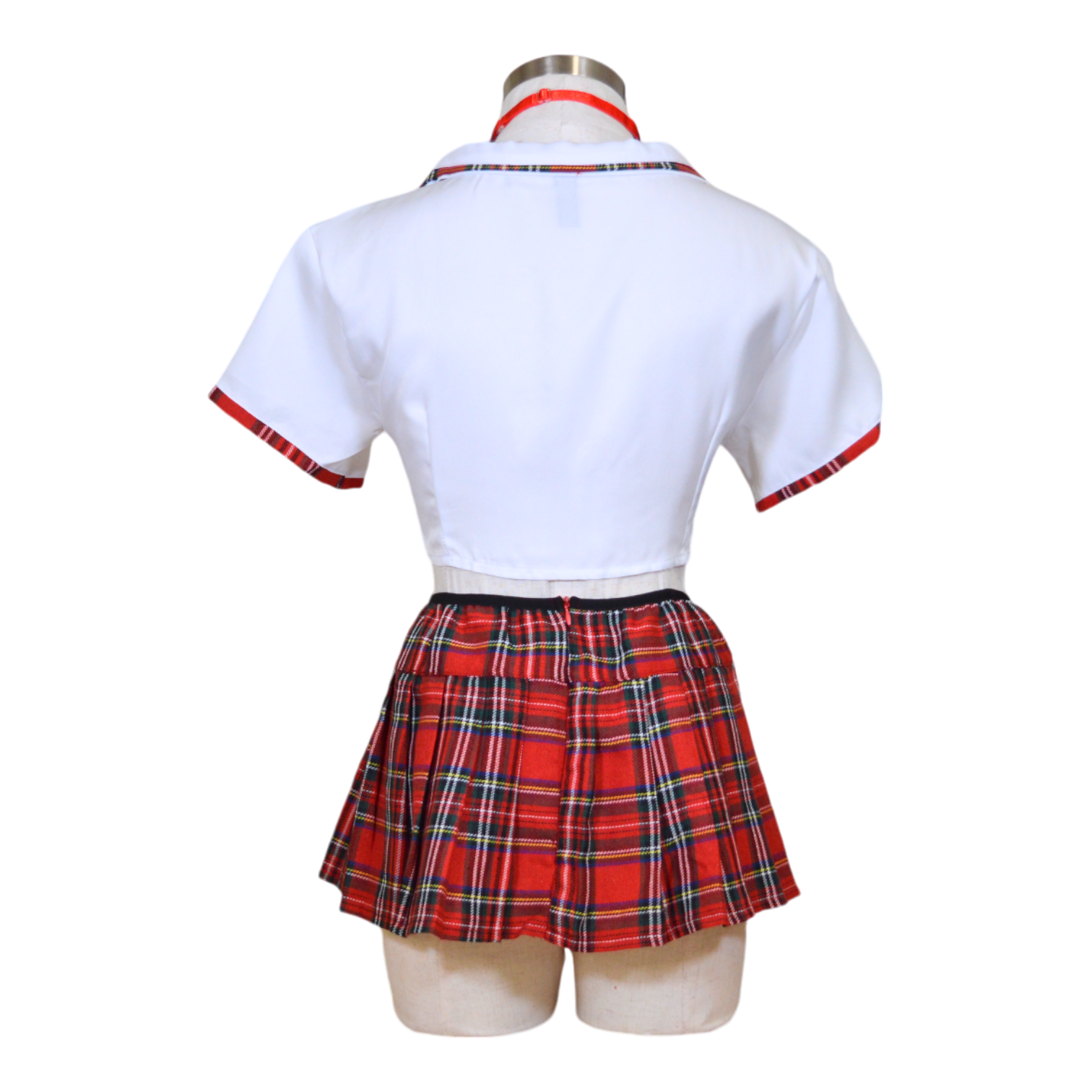 A mannequin displaying a white tie top and red and black plaid pleated skirt with neckties.