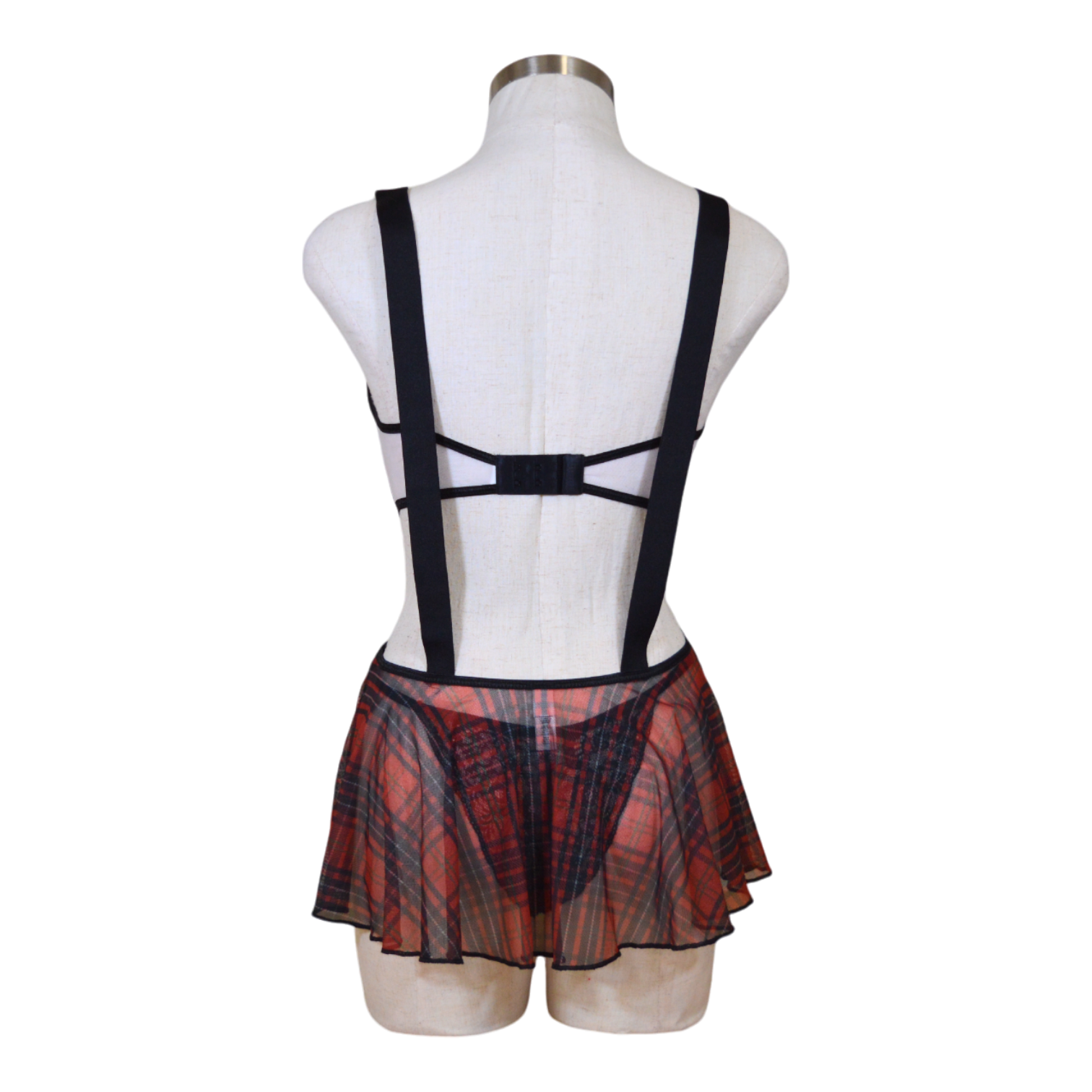 A mannequin displaying a sexy school girl costume set, including a plaid skirt and suspenders on a mannequin back view.