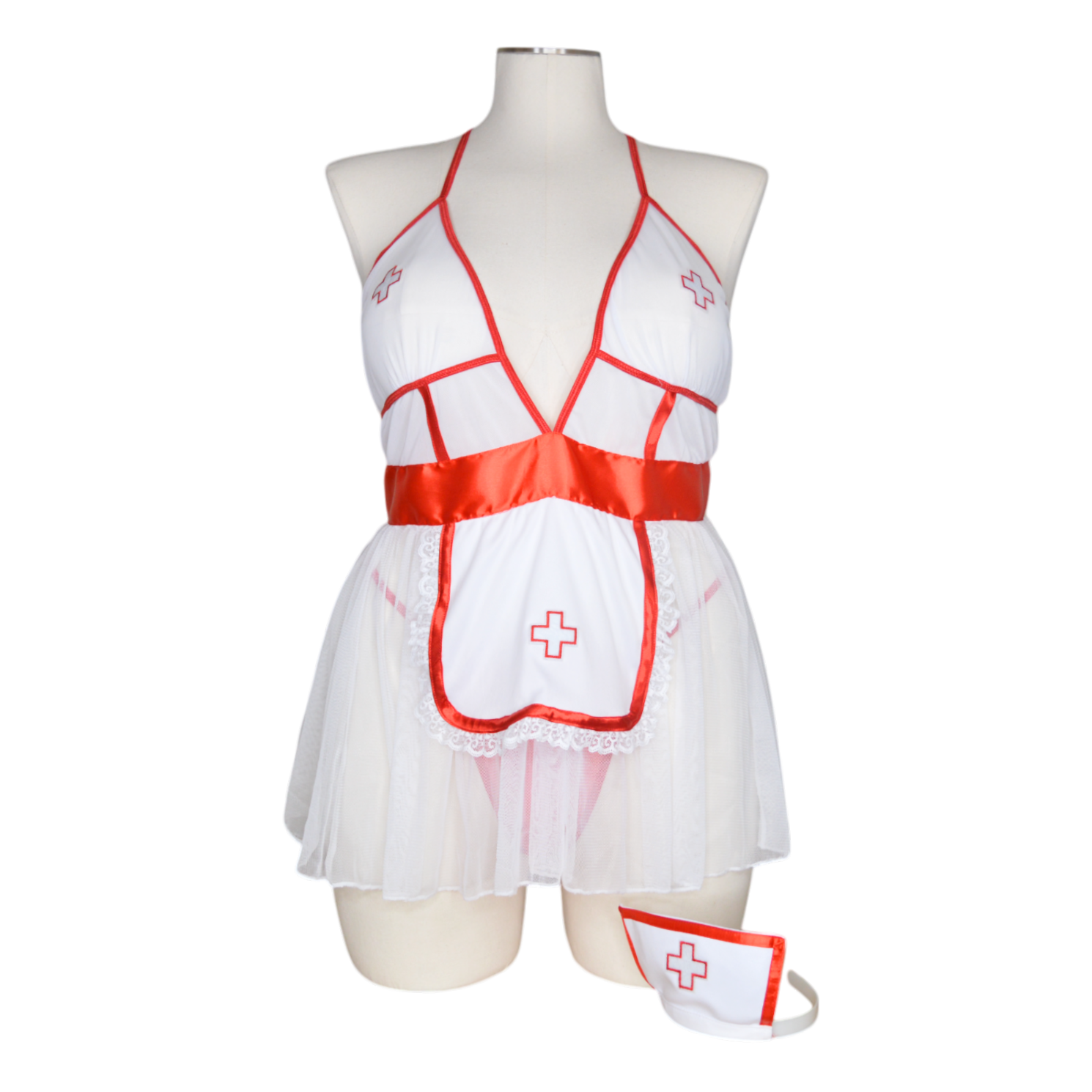 A 3 piece nightshift nurse costume set featuring a sheer white fabric with red trim, including a top, panty, and headband, with medical cross designs.