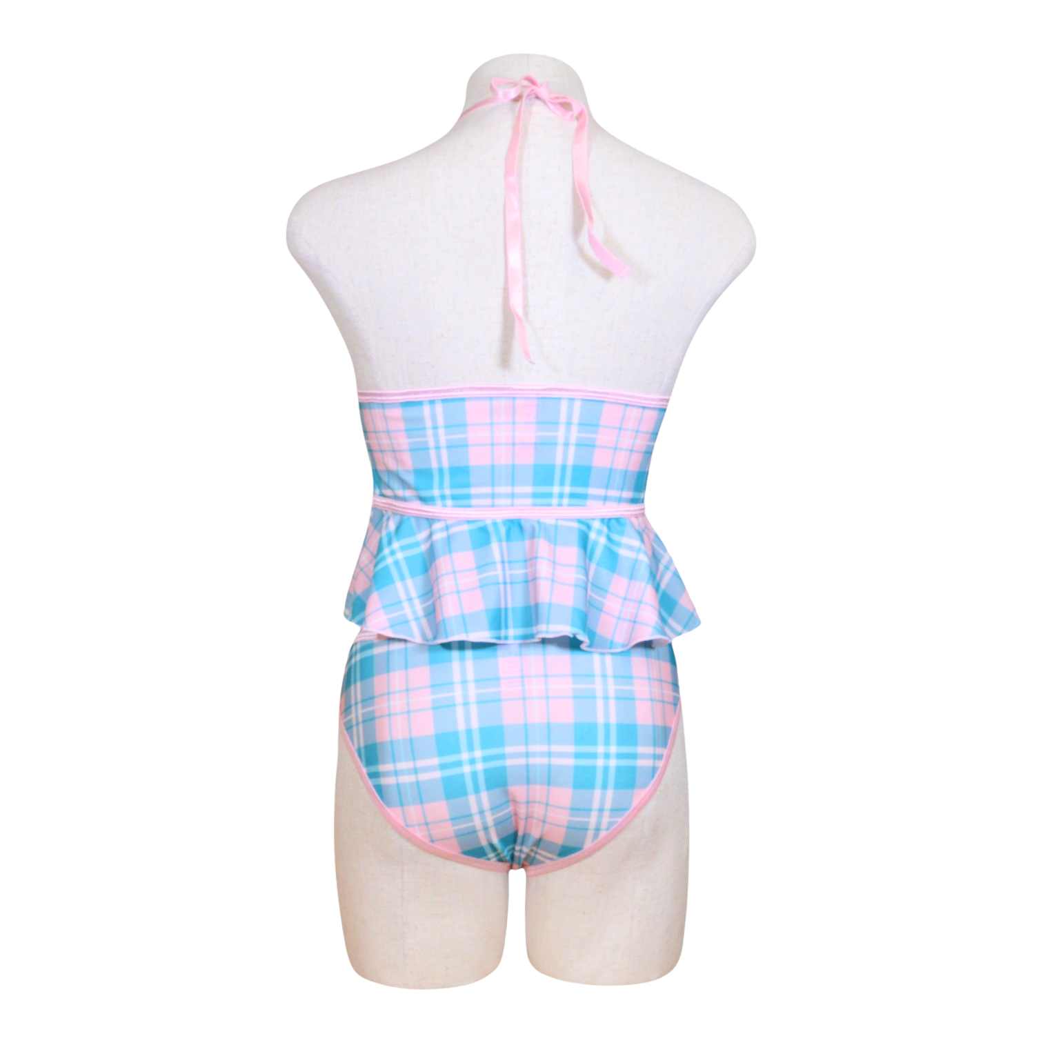 A sexy schoolgirl costume on a mannequin, featuring a cupless flutter cami in blue and pink plaid with bow accents and a color-block panty in the same design.