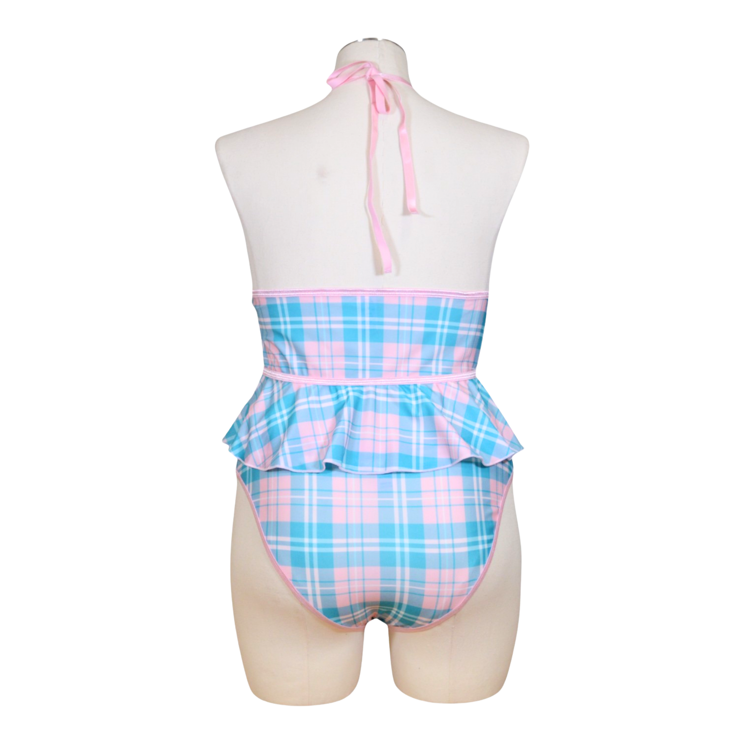 A sexy schoolgirl costume on a mannequin, featuring a cupless flutter cami in blue and pink plaid with bow accents and a color-block panty in the same design.