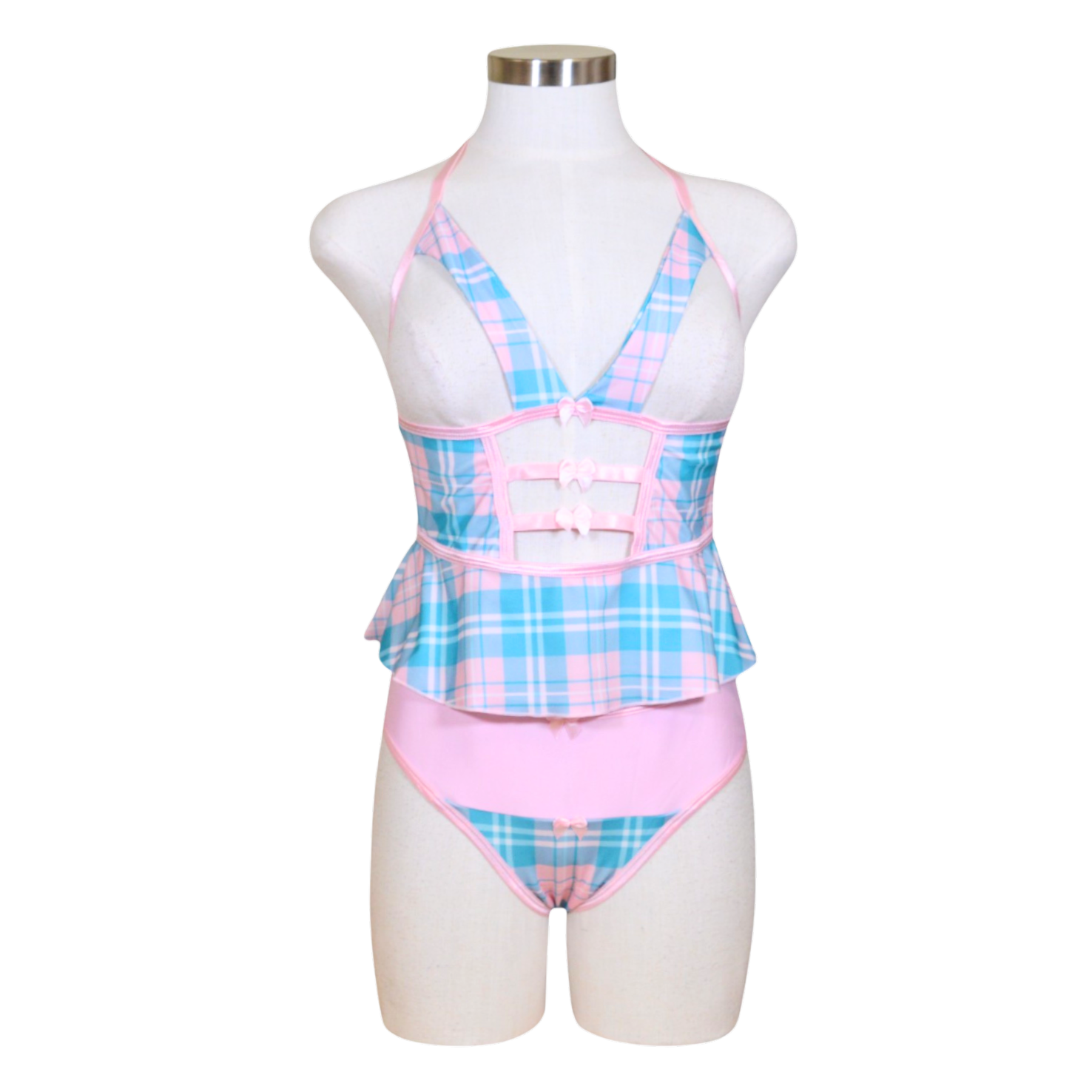 A sexy schoolgirl costume on a mannequin, featuring a cupless flutter cami in blue and pink plaid with bow accents and a color-block panty in the same design.