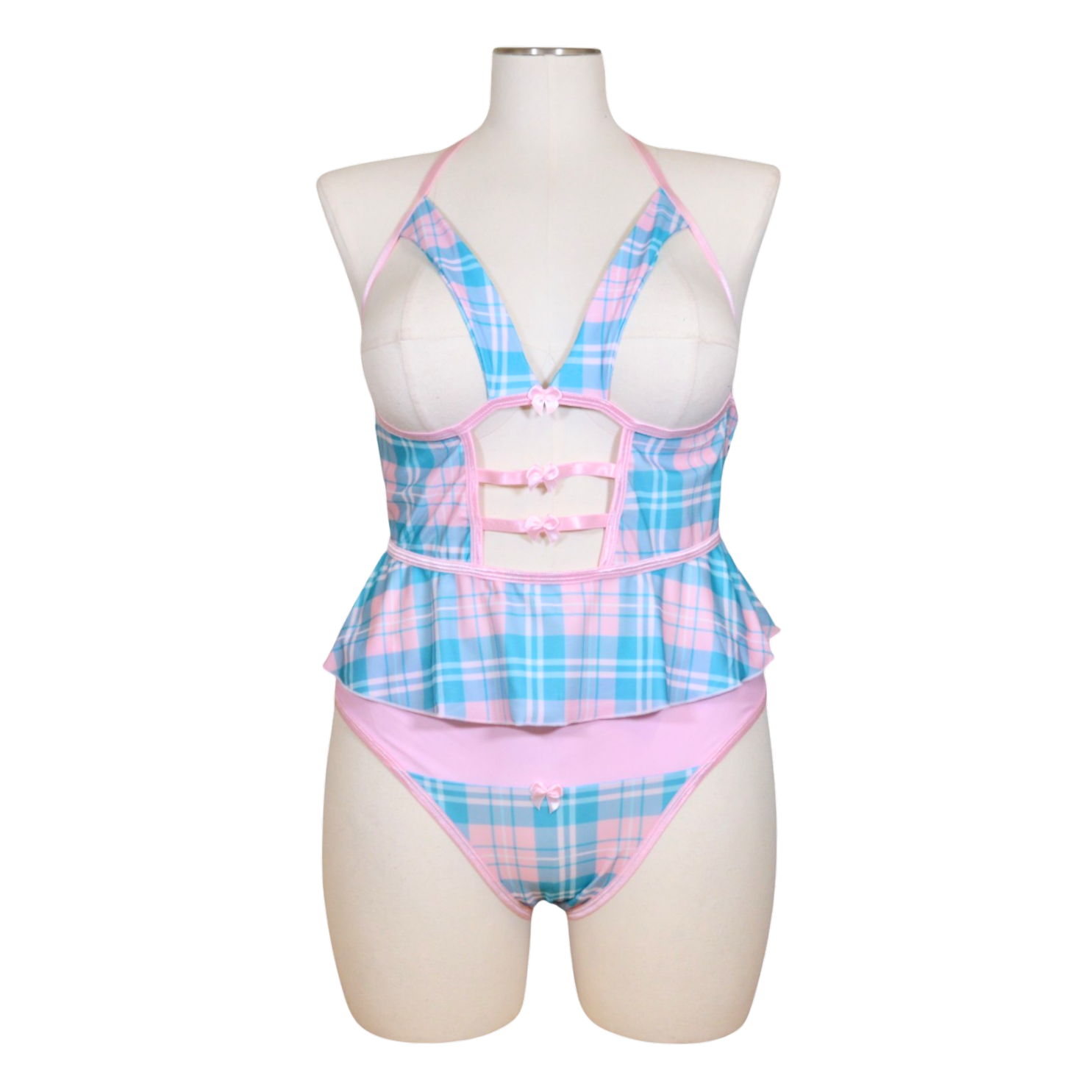 A sexy schoolgirl costume on a mannequin, featuring a cupless flutter cami in blue and pink plaid with bow accents and a color-block panty in the same design.